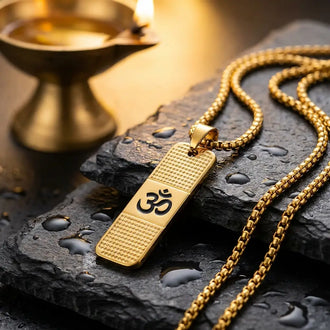 Gold plated om pendant placed on black stone