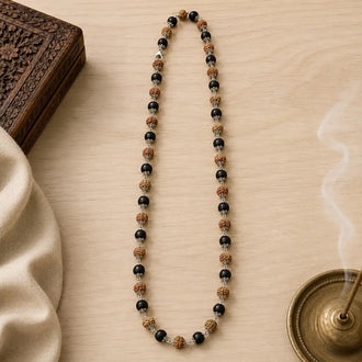 Rudraksha & karungali mala on a wooden surface
