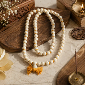 Authentic 108-bead Vrindavan Tulsi Mala with Radhe inscriptions, cream beads, and a yellow tassel.