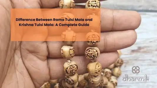 Close-up of a hand holding a sacred Tulsi mala made of carved beads, showing traditional Hindu engravings, representing the difference between Rama Tulsi Mala and Krishna Tulsi Mala.