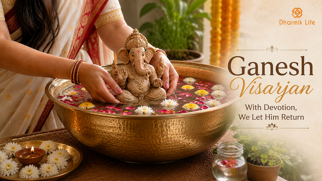 Woman in white saree immersing a Ganesha idol in a brass pot.