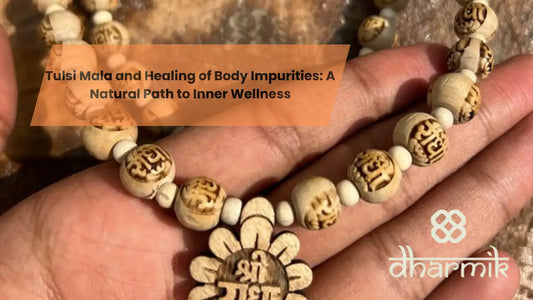Tulsi mala beads with carved sacred symbols held in hand, representing spiritual healing, purity, and inner wellness.