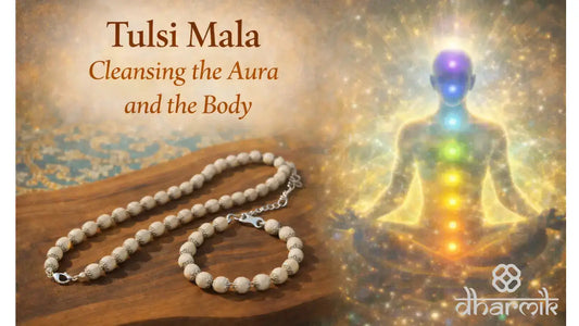 Tulsi Mala placed on a wooden surface alongside a silver-plated Tulsi bracelet, symbolizing aura and body cleansing, with a meditating human figure displaying glowing chakras in the background and the Dharmik logo.