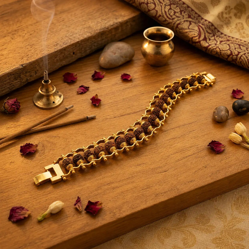 Gold plated Rudraksha bracelet on the wooden surface