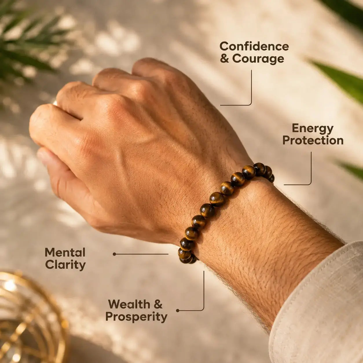 Hand wearing a beaded bracelet with labeled benefits on a blurred natural background