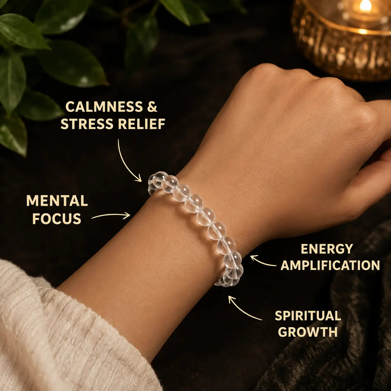 Hand wearing a clear quartz beaded bracelet with text on benefits against a dark background