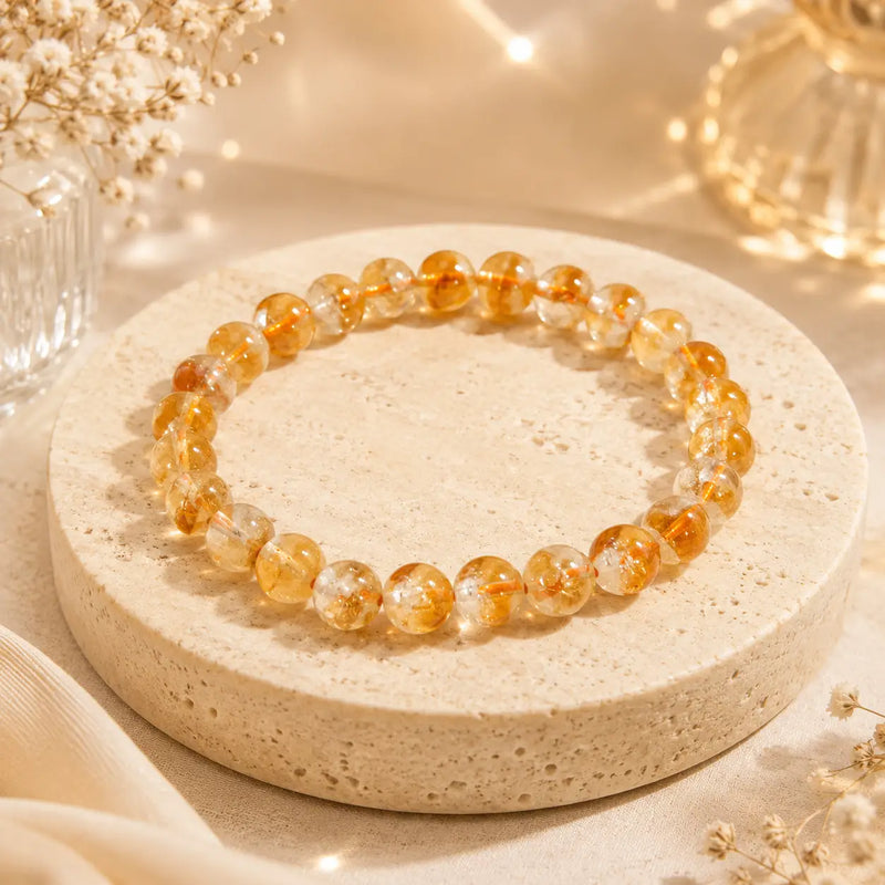 Citrine bracelet on a round stone surface with a soft, blurred background