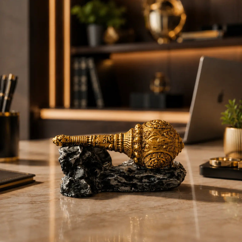 Antique gold Hanuman Gada showpiece on luxury office desk for spiritual decor.