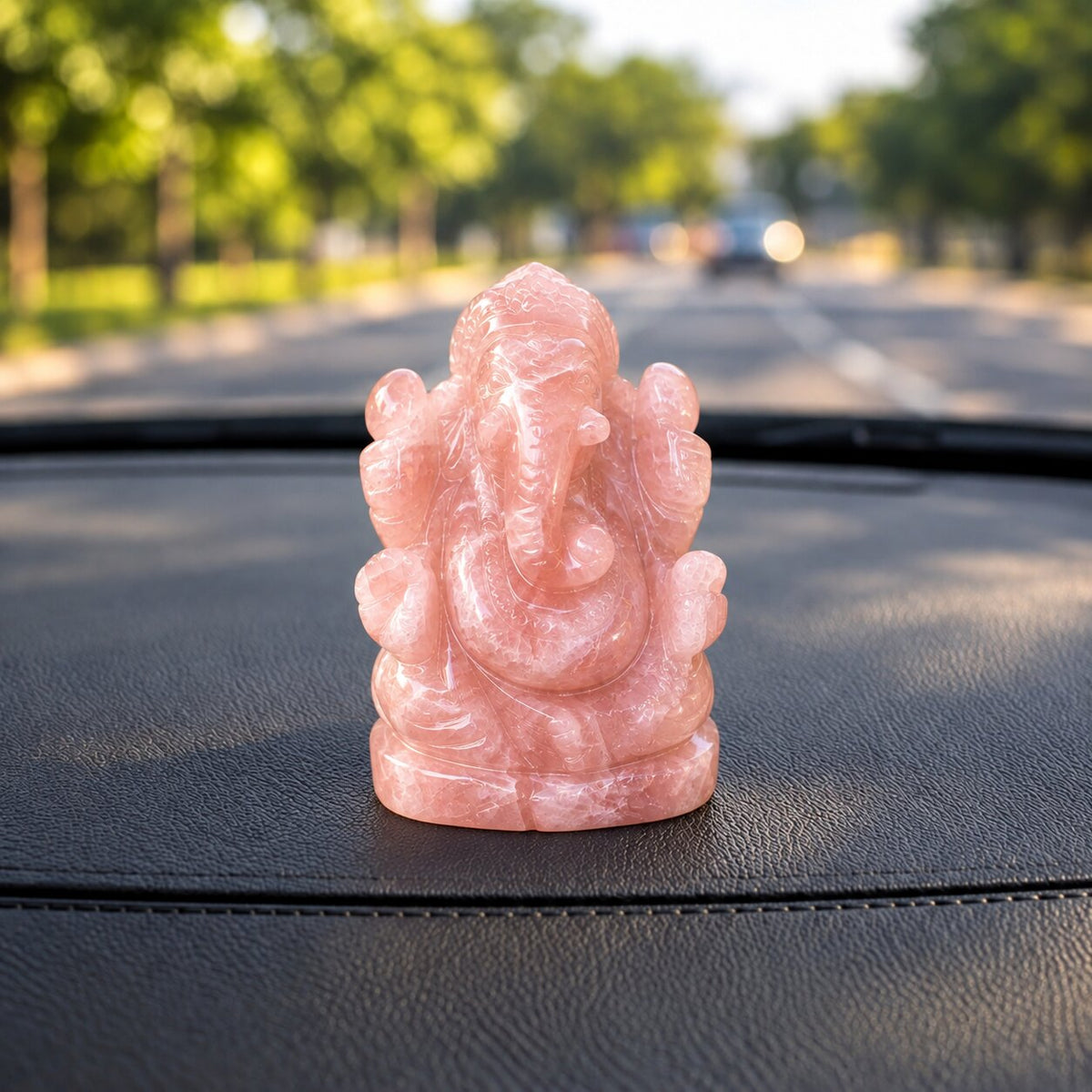 Rose Quartz Crystal ganesh ji placed on the dashboard