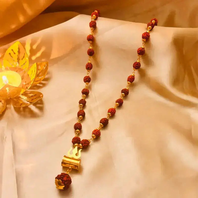 Authentic Rudraksha Mala with Brass Damru & Trishul Pendant  placed on a cloth