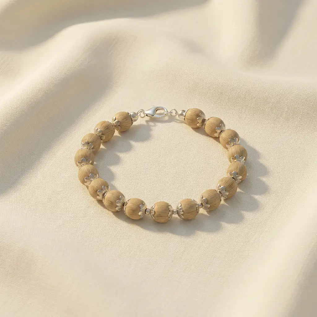 silver plated tulsi mala bracelet 17 beads 10mm, placed on a white cloth