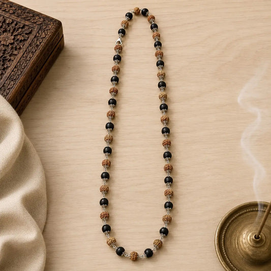 Rudraksha & karungali mala on a wooden surface