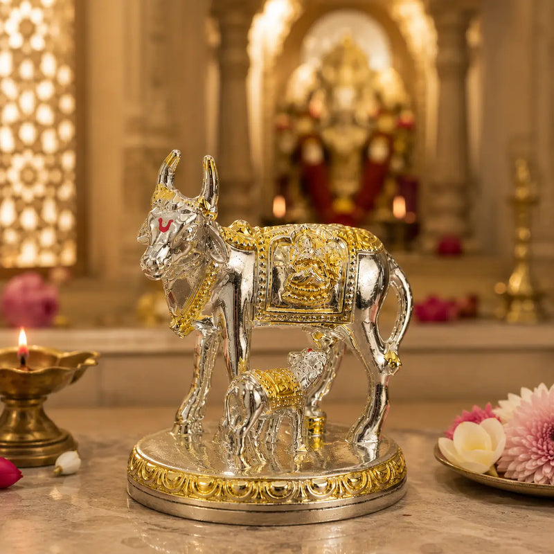 DharmikLife Kamadhenu Cow and Calf silver-gold idol in a temple setting.