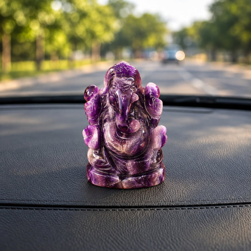 Amethyst Crystal ganesh ji placed on a dashboard of a car