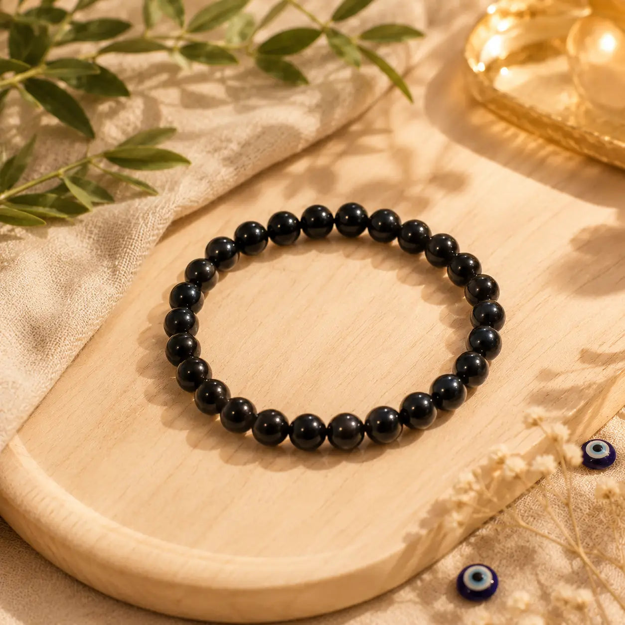 Black tourmaline  beaded bracelet on a wooden surface with a natural background