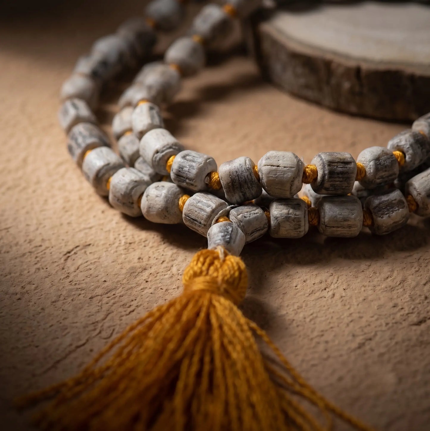 Zoomed Tulsi Japa Mala with 108 Original Big Beads placed on a wooden plate.
