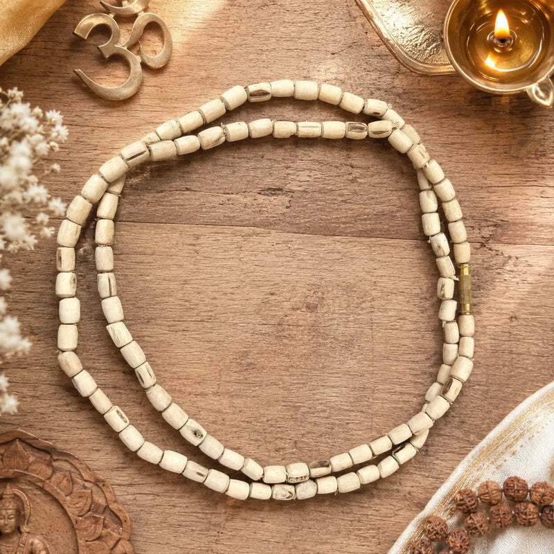 Dhan Mala 8mm placed on a flat wooden plate