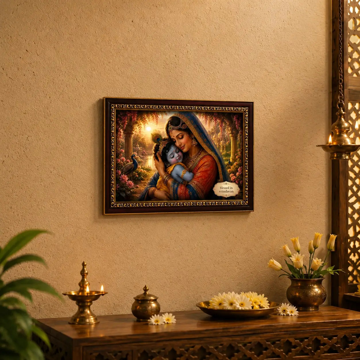 Framed artwork of yashoda and baby krishna on a wall with decorative items on a table below.