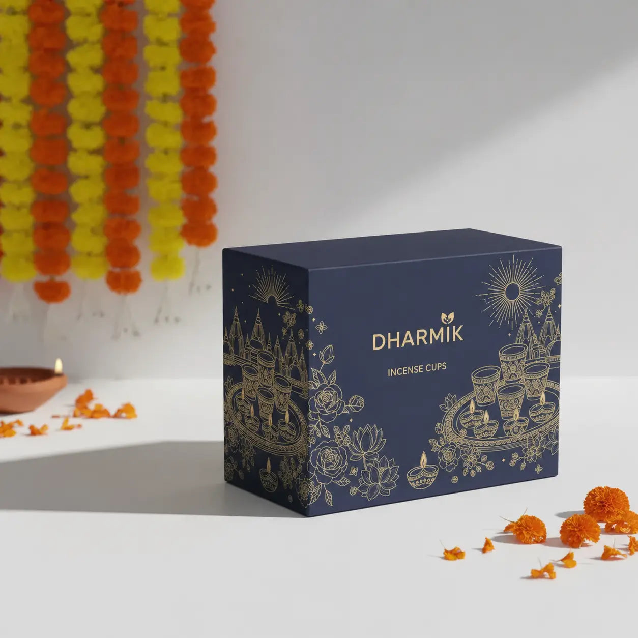 Box of Dharmik incense cups with decorative elements on a white background