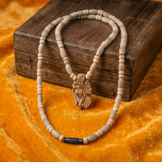Original Tulsi Mala with Radha Krishna Pendant – Single Round, 10 mm, placed on a wooden box 
