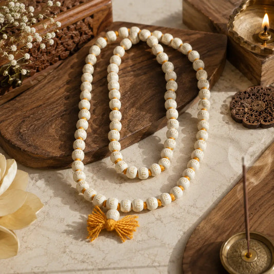 Authentic 108-bead Vrindavan Tulsi Mala with Radhe inscriptions, cream beads, and a yellow tassel.
