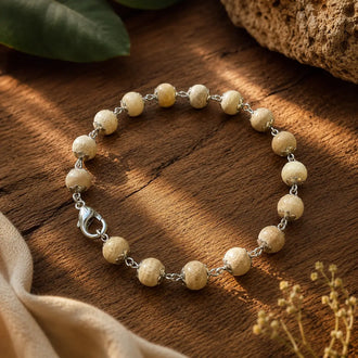 Silver Plated Tulsi Bracelet – 17 Beads, 10 mm, placed on a wooden plate
