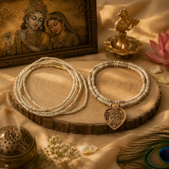 Authentic Vrindavan Tulsi wood Kanthi malas with an antique Radha Krishna pendant on a rustic display.